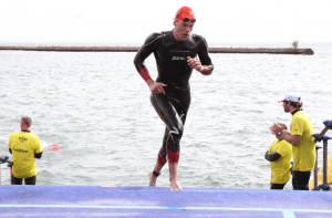 Angus Smith finishes the swimming section of a triathlon